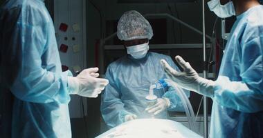 A team of surgeons are preparing for an operation in a modern operating room. The anesthesiologist puts on a mask with anesthesia on the patient. in 4k, red komodo video