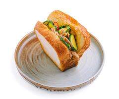 Delicious sandwich filled with tender meat and fresh vegetables on rustic plate photo
