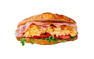Delicious croissant sandwich filled with ham, scrambled eggs, and fresh vegetables made for a satisfying breakfast photo
