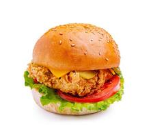 Crispy fried chicken sandwich with lettuce, tomato, and cheese on a sesame seed bun served on a white background photo