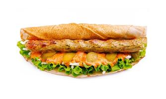 Savory grilled kebab sandwich with fresh vegetables served on a warm pita bread for a delicious meal experience photo
