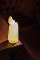 Refreshing cocktail served in a glass with crushed ice and a pineapple garnish on a wooden table photo