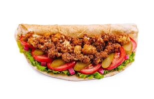 Crispy fried cauliflower wrap with fresh vegetables and tangy pickles served on a soft flatbread photo
