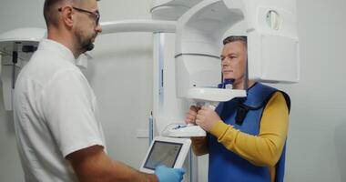 Panoramic x-ray of the patient's jaw. Diagnostic equipment orthopantomographic device for teeth, MRI. Creates a 3D model of teeth and gums on the doctor's screen. in 4k, red komodo video