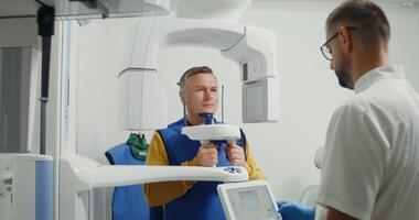 Patient inside a panoramic 3d tooth scanner. Diagnostic equipment orthopantomographic device for teeth, MRI. Creates a 3D model of teeth and gums on the doctor's tablet. in 4k, red komodo video