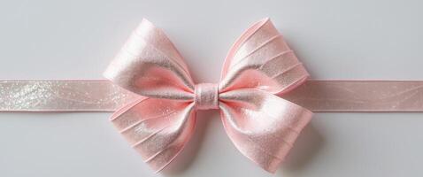 Decorative pink ribbon bow ideal for gift wrapping or craft projects featuring shimmering texture and unique design. photo