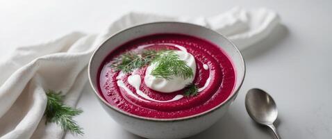 Steaming Bowl of Red Beetroot Soup with Cream and Dill photo