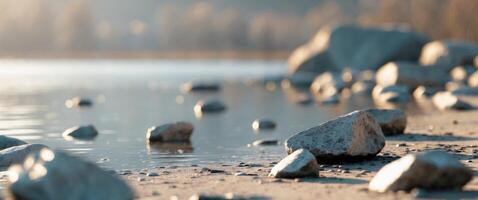 Scattered Rocks on Ground by Water in Soft Daylight. photo