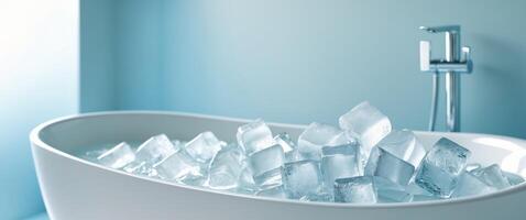 Bathtub filled with ice cubes in a serene bathroom setting featuring a calming blue background and elegant design. photo