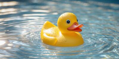 close up yellow rubber duck floating in pool water photo