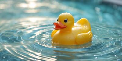 close up yellow rubber duck floating in pool water. photo