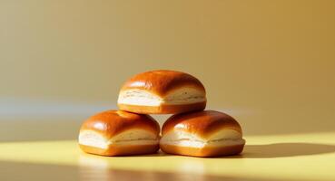 Soft brioche buns with a shiny golden crust displayed on a bright yellow background to showcase their fresh appearance photo