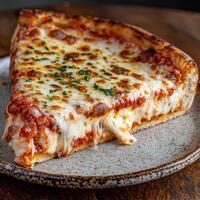 A delicious slice of cheesy pizza on a plate photo