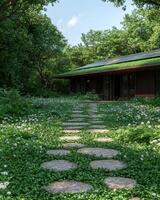 Modern house with a green roof and stone pathway in a lush garden photo