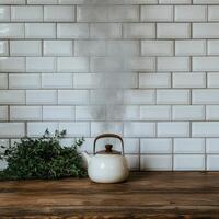 A steaming kettle sits on a wooden counter with fresh herbs photo