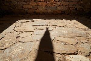 Shadow of a person on a stone floor in a building photo