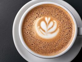 Overhead view of a cappuccino with latte art in a white cup on a saucer photo