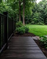 A modern deck and landscaping in a backyard photo