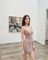 Young Woman in Slim Dress Posing in Art Gallery Interior Space photo