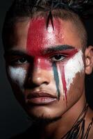 Portrait of a man with tribal face paint photo