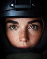 Close up portrait of a woman with freckles wearing a helmet photo