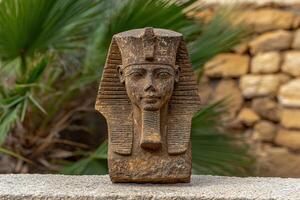 Ancient egyptian pharaoh bust on display outdoors photo
