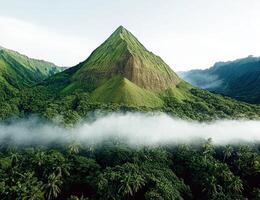 Lush green mountain landscape with low clouds photo