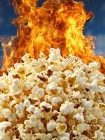 A pile of popcorn in front of a fiery background photo