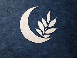 Crescent moon and branch on a textured blue background photo