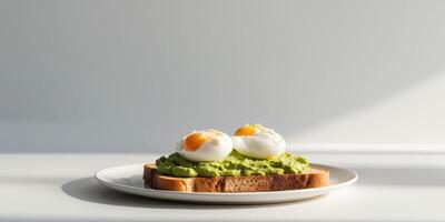 A plate of toast with avocado spread and poached eggs photo