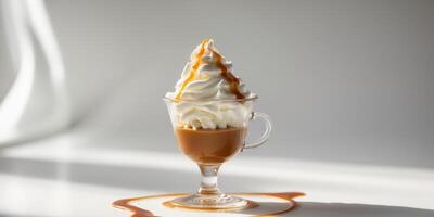 Delicious creamy dessert in cup topped with whipped cream and caramel. photo