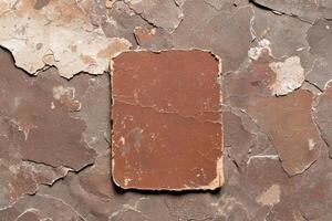 A textured brown surface with peeling paint and a rectangular paper element photo