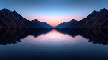 A serene mountain landscape reflecting in calm water at dusk photo