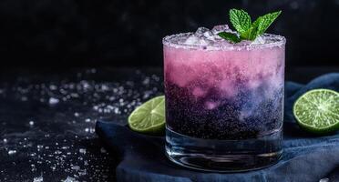 A refreshing purple cocktail with ice and mint garnish photo