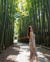 Elegant Woman in Serene Bamboo Forest Pathway Scene photo