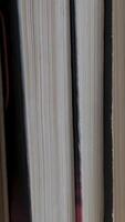 Book shelf's in library. Close up Many books organized in shelves in a big bookstore. The concept of learning, reading, and knowledge. Vertical video