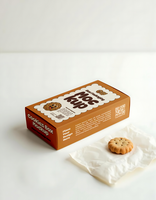 A box of Moc Kup cookies with a single cookie beside it psd