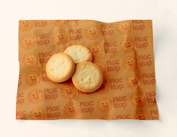 Three shortbread cookies rest on a piece of patterned baking paper psd