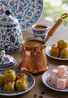 Traditional Middle Eastern Sweets and Coffee on Decorative Table photo