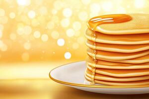 Stack of pancakes, topped with syrup or honey on golden background, with copy space photo
