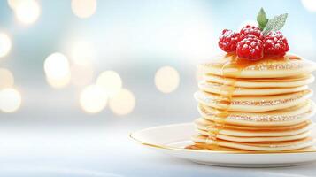 Stacking golden pancakes with honey, topped with raspberries and powdered sugar, copy space photo