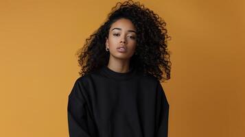 A young woman with curly hair wearing a black sweater photo