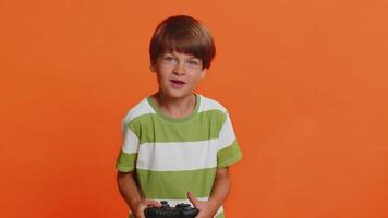 Child boy using joystick controller playing console television game enjoying success winning video