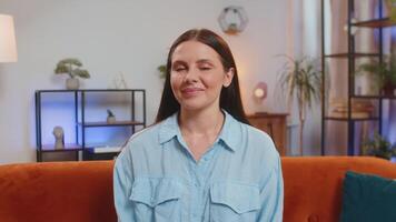 Portrait of happy calm Caucasian woman at home couch smiling friendly, looking at camera resting video