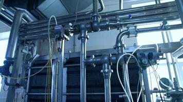 Silver stainless pipelines at a dairy factory. Tubes and pipes of different diameter and controller box in the modern milk enterprise. Close up. video