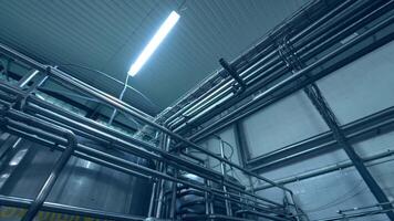 A number of steel tubes intertwisting with each other. Premises with tubes lit by the daylight lamps. View from the below. video