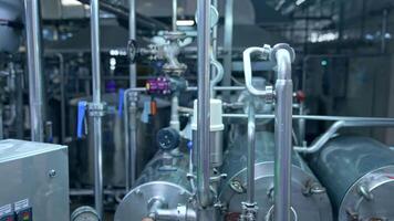 Close look at the pipelines with valves and barometer. Special equipment with buttons and timer for controlling the production processes. Close up. video