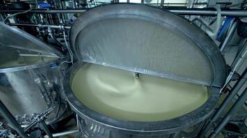 Two big steel tanks full of cream with automatic mixing. Metal reservoirs with open lids at the modern milk factory. Close up. video