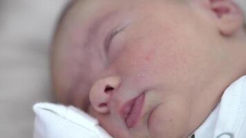 Adorable babe sleeping peacefully with its hand under the chick. Rosy cheeks, tiny nose and lips close up. video
