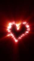A glowing red heart made of sparkling particles, radiating warmth and passion against a dark background. Perfect for romance video